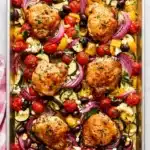 Greek Sheet Pan Chicken with roasted vegetables, feta, olives, and juicy chicken thighs.