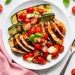Grilled Chicken Caprese with tomatoes, mozzarella, basil, balsamic glaze, and grilled zucchini