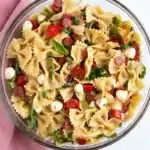 Hot Honey Pasta Salad Recipe with bowtie pasta, mozzarella, pepperoni, tomatoes, and fresh herbs