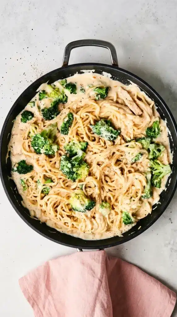 Low Calorie Chicken Alfredo | Amazing Easy Creamy Recipe 7 Low Calorie Chicken Alfredo cooking in a skillet with creamy pasta and broccoli