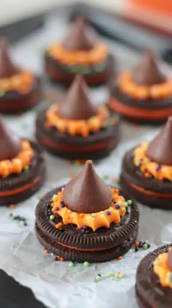 Oreo Witch Hat Cookies with orange frosting and chocolate kisses