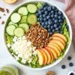 Peach Berry Summer Salad | Fresh and Easy Summer Recipe 9 Peach Berry Summer Salad with blueberries, cucumber, feta, pecans, and fresh peaches in a white bowl.
