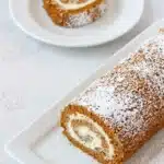 Pumpkin roll slice with cream cheese filling and powdered sugar