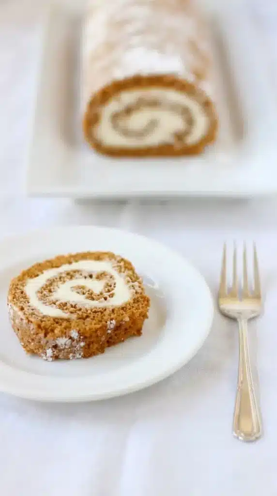 Served pumpkin roll slice with cream cheese filling