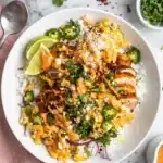 Street Corn Chicken Rice Bowl with grilled chicken, creamy corn, rice, cotija cheese, cilantro, and lime