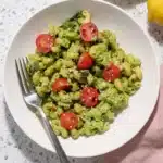 Creamy Vegan Avocado Pesto Pasta with cherry tomatoes in a bowl