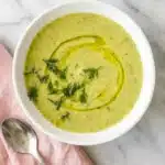 Zucchini Soup : Easy Recipe for a Happy, Cozy Meal 11 Creamy Zucchini Soup with fresh herbs and olive oil in stoneware bowls