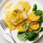 Baked Cod Beurre Blanc with silky orange butter sauce, citrus and fresh greens