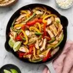 Chicken Fajitas Recipe | Amazing Easy 30 Minute Meal 9 Chicken Fajitas with grilled chicken, colorful peppers, onions, and lime in a cast iron skillet