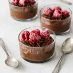 Chocolate Chia Pudding topped with raspberries and dark chocolate shavings