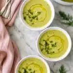 Zucchini Soup Recipe | Amazing Creamy Dinner You'll Love 9 Creamy Zucchini Soup topped with olive oil and fresh dill in white bowls.