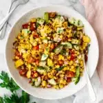 Fresh Corn Salad Recipe | Amazing Easy Summer Lunch 9 Fresh Corn Salad with grilled corn, cucumber, tomatoes, herbs, and red onion in a serving bowl
