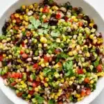 Cowboy Caviar with black beans, corn, avocado, tomatoes, peppers, and fresh cilantro