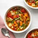 Homemade Vegetable Soup with potatoes, carrots, green beans, peas, corn, tomatoes, and fresh parsley