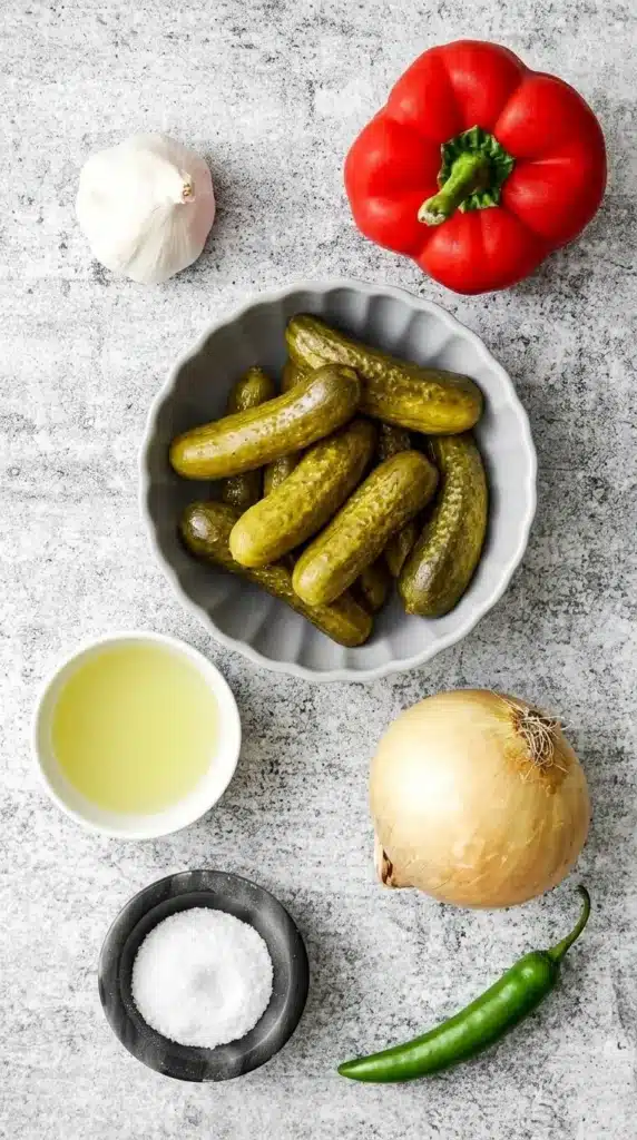 Pickle de Gallo ingredients with dill pickles, red pepper, onion, serrano, garlic and brine