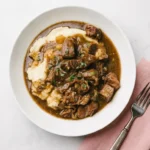 Instant Pot Beef Tips served over creamy mashed potatoes with rich gravy