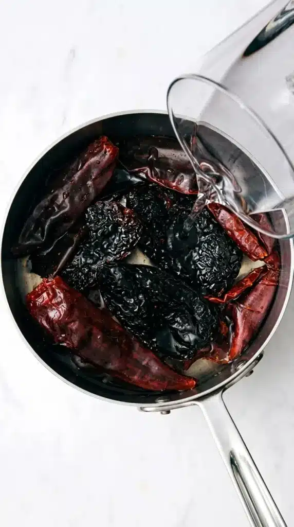Dried chiles soaking in hot water for slow cooker Birria sauce