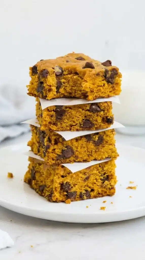 Pumpkin Blondies : Amazing Soft Fall Dessert 5 Pumpkin Blondies with chocolate chips stacked to show their soft, moist centers