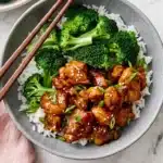 Teriyaki Chicken with glossy sauce, steamed broccoli, white rice, sesame seeds, and green onions
