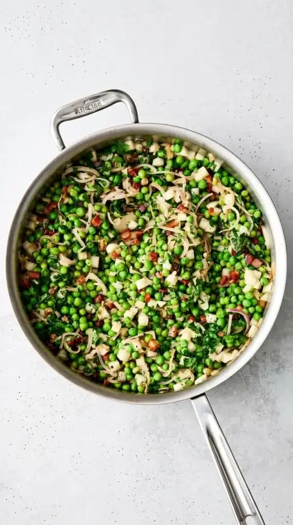 Thanksgiving Peas with crispy pancetta, pear, shallots, and fresh parsley in a skillet