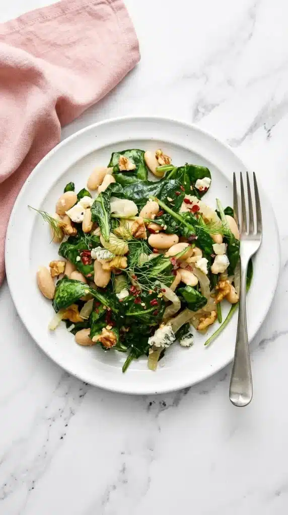 Warm Spinach and White Bean Salad with fennel, Gorgonzola, walnuts, and red pepper flakes