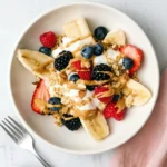 Breakfast banana split with yogurt, berries, granola, and almond butter