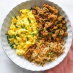 High Protein Breakfast Bowl with turkey, fluffy eggs, crispy potatoes, and fresh chives