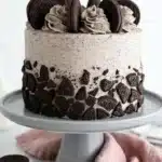 Oreo Layer Cake Recipe with cookies and cream buttercream and chocolate cookie pieces