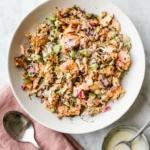 Salmon Salad with flaky baked salmon, crisp vegetables, herbs, and creamy lemon Dijon dressing