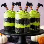 Witches' Brew Halloween Cake Jars : Easy Wicked Treat 7 Witches' Brew Halloween Cake Jars with green frosting, dark cake layers, sprinkles, and witch legs