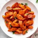 Easy Thanksgiving Honey Glazed Carrots Recipe : Amazing Side 7 Easy Thanksgiving Honey Glazed Carrots with golden caramelized edges and fresh parsley in a ceramic bowl