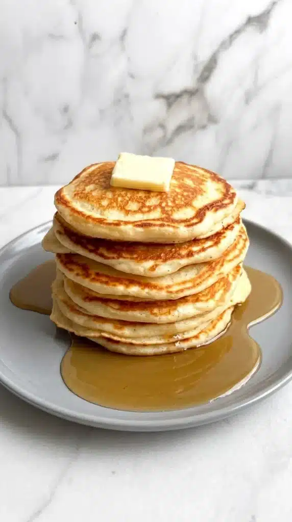 Greek Yogurt Pancakes stacked with butter and maple syrup