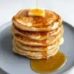 Stack of Greek Yogurt Pancakes with butter and maple syrup