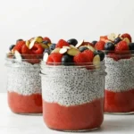 How to Make Chia Pudding with creamy vanilla chia seeds, berry puree, fresh berries, and sliced almonds