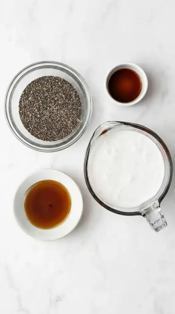 How to Make Chia Pudding ingredients: milk, chia seeds, maple syrup, and vanilla extract