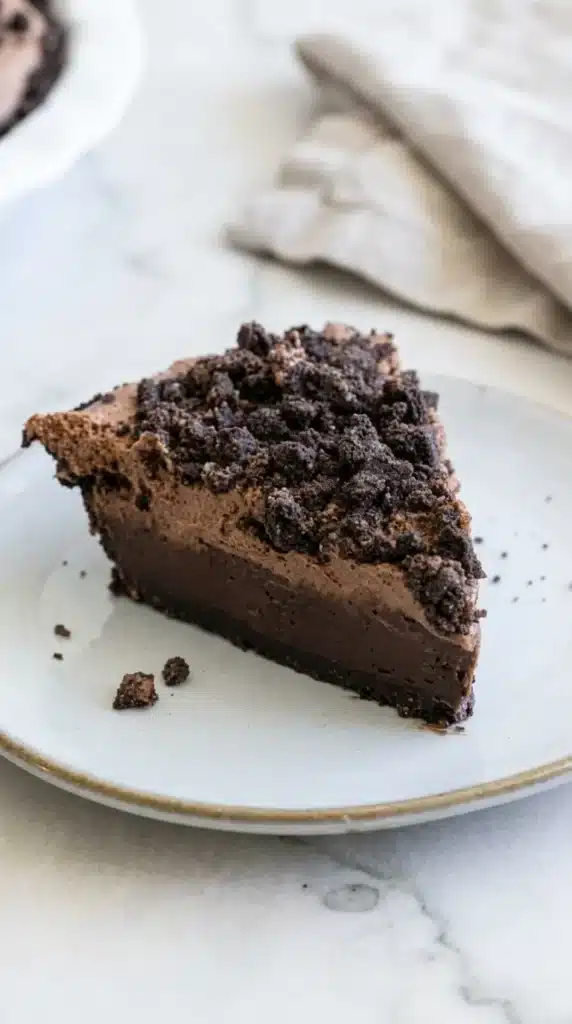 Mississippi Mud Pie slice with fudgy brownie, chocolate mousse, and crunchy Oreo topping