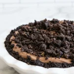 Mississippi Mud Pie slice with Oreo crust, fudgy brownie, chocolate mousse, and cookie topping